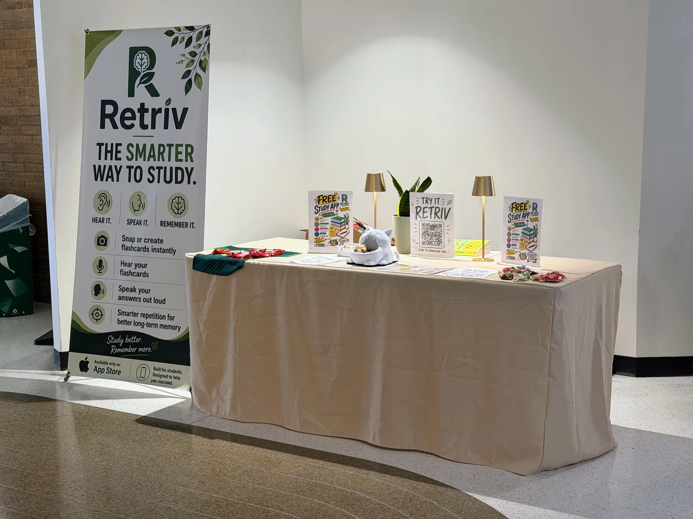 Retriv booth setup with banner and QR download signage